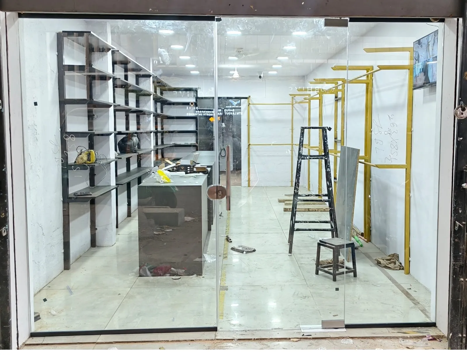 Team of Fashion Elite Glass Works installing large frameless glass partition in Bangalore office