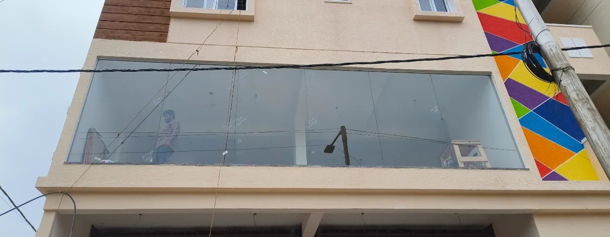 Frameless floor-to-ceiling glass office partition installation in Bangalore commercial space