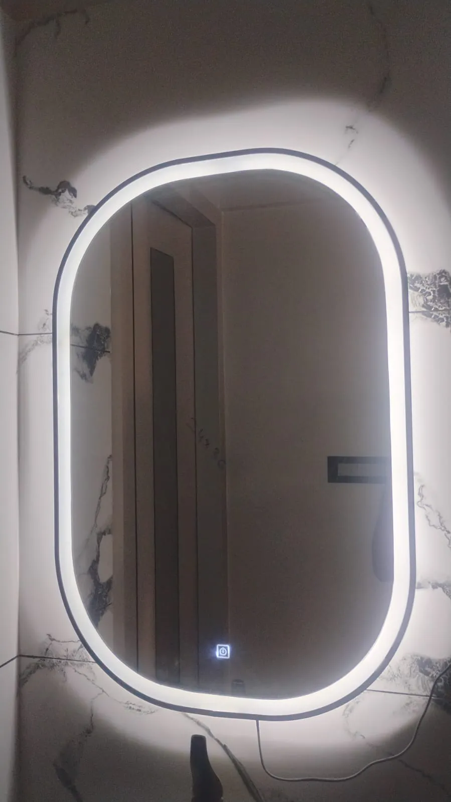 Round LED backlit bathroom mirror with touch sensor installed in Bangalore home