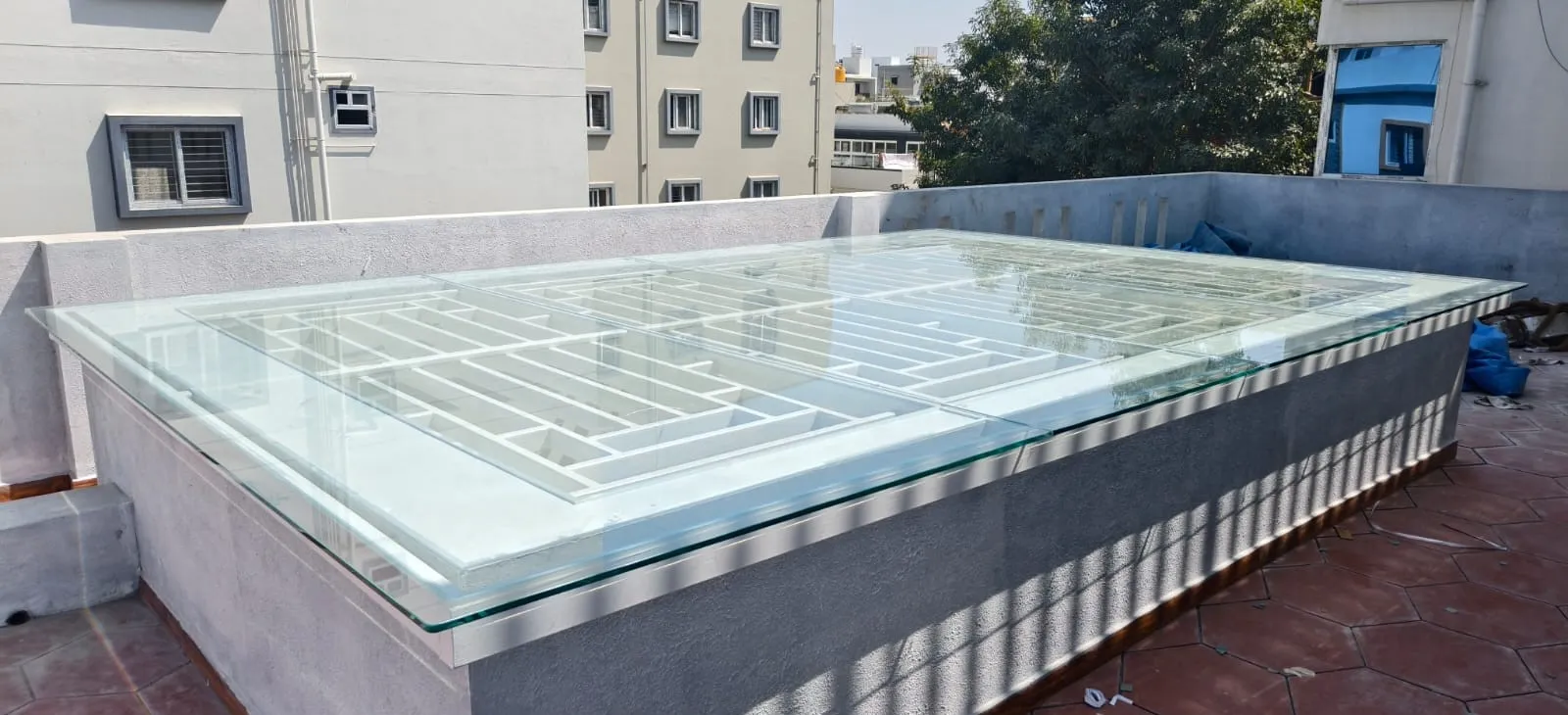 Structural glass walkway and floor installation with white grid support frame